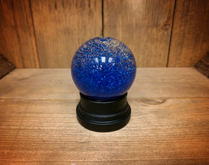 Image of the blue glitter globe after being shaken.