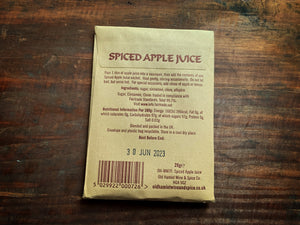 Image shows the back of a kraft paper pouch of Spiced Apple Juice spices. The back has the ingredients and instructions for use.