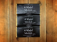Load image into Gallery viewer, Image shows all three A Blissful Interlude chocolate bars in milk, white and dark. All packaging is the same with a black wraparound label and gold foil.